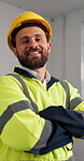 Construction, face and man on site with arms crossed, contractor and ambition in building renovation. Portrait, happy and engineer with confidence, developer pride and about us in remodeling industry
