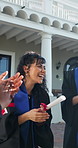 Smile, woman and students applause at graduation, ceremony and diploma for degree completion. Happy, people and high five outdoor for celebration, academic excellence and award for learning milestone