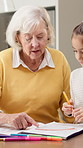Homework, grandmother and girl in kitchen with support, art project and help with homeschool task. Education, grandparent or kid with creative activity, family guidance or assistance in home learning