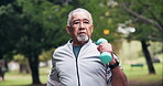 Dumbbell, exercise and old man in park with walk, cardio workout or training for retirement wellness. Serious, active senior person and marching outdoor with weights, movement or fitness for vitality