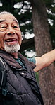 Senior, man or hiking with tour in forest for outdoor sightseeing, travel or POV tutorial in nature. Elderly, male person or hiker showing with trees or vlog for navigation, journey or adventure