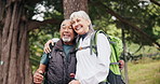 Hiking, break and old couple in nature with hug, smile or adventure together for retirement wellness. Happy, senior people and embrace outdoor in woods with trekking, love or interracial relationship
