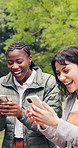 Women, laugh and talk in university with phone, funny online gossip and check social media on break. Happy, friends and outdoor on college campus with tech, discussion and share meme on internet.