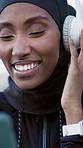 Black woman, headphones and phone outdoor for fitness, streaming and podcast for exercise break. Smile, muslim person and relax in city with mobile, listening to music and download audio for training