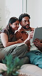 Couple, home and talking with tablet for online planning, ai app or interior design in lounge. Happy man, woman and technology on sofa with subscription, remodelling and visual for house layout
