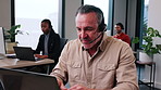 Consulting, man and happy with laptop in call center for needs assessment, loan advice or assistance. Coworking, mature agent and talk with tech for insurance claim, client info and check eligibility