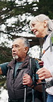 Elderly, hiking and happy couple in forest for sightseeing, outdoor adventure or journey together. Active, senior man and woman with smile or walking stick for trekking, fitness or travel in nature