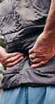Senior person, discomfort and back pain for fitness, condition and fatigue of exercise accident. Hands, elderly man and muscle cramps in nature with fibromyalgia, inflammation and training injury