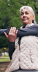 Senior, woman and stretching with arm in nature for outdoor workout preparation or training. Active, elderly or female person getting ready with body warm up for exercise, health or wellness in park