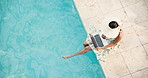 Woman, laptop and remote work at resort with pool, internet or digital nomad with copywriting career. Above, space and person outdoor at hotel with computer, freelance copywriter job and online blog.