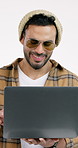 Smile, man and typing in studio with laptop, social media and streaming for latest movie release. Happy, person or laugh with tech, internet search and watchlist of trending video on white background