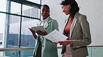 Walking, documents and women on tablet in lobby for planning, finance review and investor update. Office, business and people with tech, paperwork and financial report for budget, proposal or talking