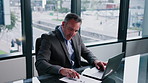 Laptop, typing and man in office with paper for financial report, income statement or accounting. Reading document, computer and mature person in corporate enterprise, audit review or balance sheet