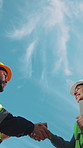 Engineer, people or handshake with team at construction site, meeting or development partnership. Architecture collaboration, happy worker or shaking hands, agreement or low angle with tablet outdoor