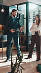 Realtor, client and conversation at open house with clipboard, furniture quality and sales pitch. Man, woman and real estate with checklist, property tour for investment or purchase of new home