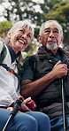 Senior, relax and happy couple in nature for hiking adventure, sightseeing or outdoor journey. Active, elderly man and woman with walking stick, smile or view for trekking trip or bonding in forest