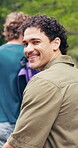 Walking, face and man at university outdoor for travel, journey and trip to class for learning. Portrait, campus and student with backpack for education, study opportunity and knowledge at college