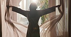 Woman, window and open curtain for morning sunshine, wake up and luxury bedroom in hotel room. Back, flare and female person in bathrobe for accommodation, thinking and vacation or holiday stay